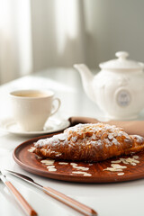 Almond Croissant on clay plate close up