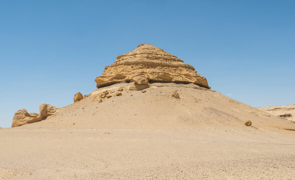 Barren desert landscape in hot climate with mountain rock formation