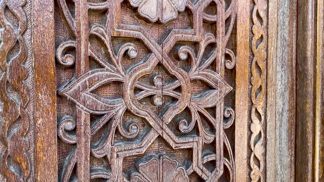 Wooden carving patterns on the doors of a Muslim mosque