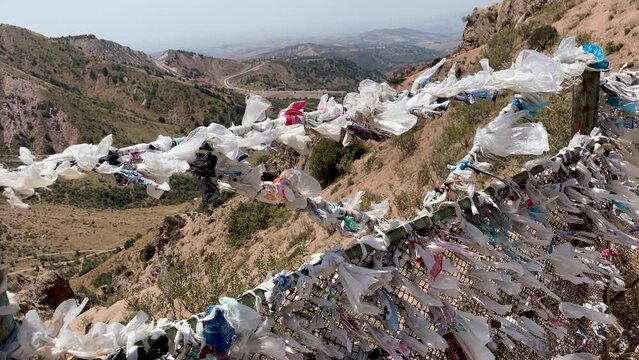ribbons of desires tied to fancy against backdrop of a mountain and blue sky on Chimgan mountain, Uzbekistan