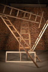 Old wooden step ladders on the construction site background. Building house abstract background.