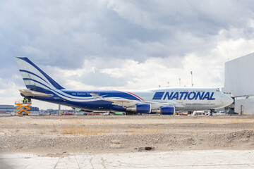 Obraz premium Toronto, Canada, April 7, 2023; A full side view of a National Airlines Boeing 747 cargo jumbo jet from Anchorage Alaska on the tarmac at Toronto Pearson Airport YYZ