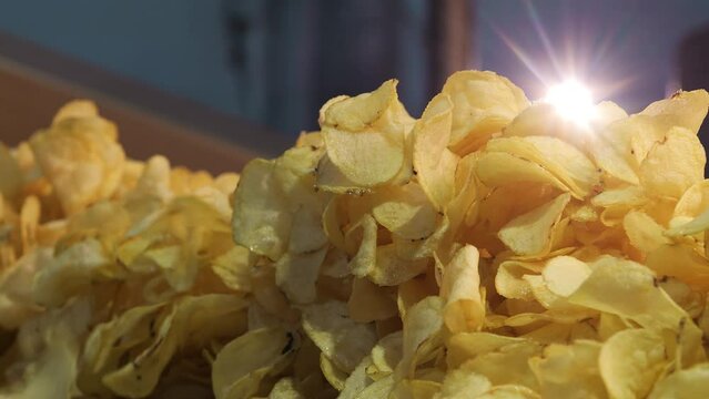 Close up of fried potato chips at industrial food factory.