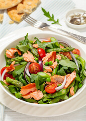 smoked salmon salad with spring veggies in bowl