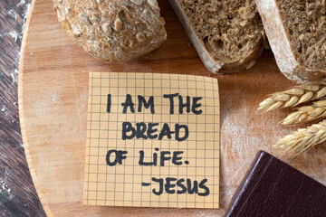 I am the bread of life, Jesus Christ, handwritten text note with wheat and closed holy bible book...