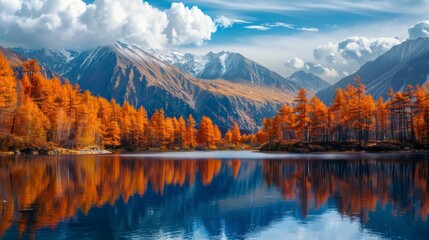 landscape of a lake with large mountains and orange trees in autumn in high resolution
