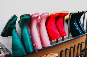 Colorful rubber boots hanging in front of winery quality control room
