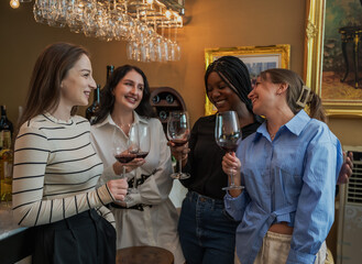 Group of young women drinking wine celebrating friendship in bar and restaurant