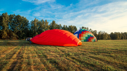 Ballooning festival on balloons preparation for flights, installation of balloon equipment, pilots set up a balloon in the field.