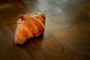 traditional french croissant on wooden table
