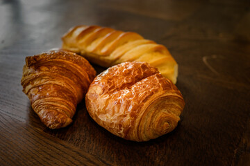 variety of french viennoiseries on wooden surface