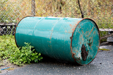 old oil or chemical barrels discarded in an industrial site
