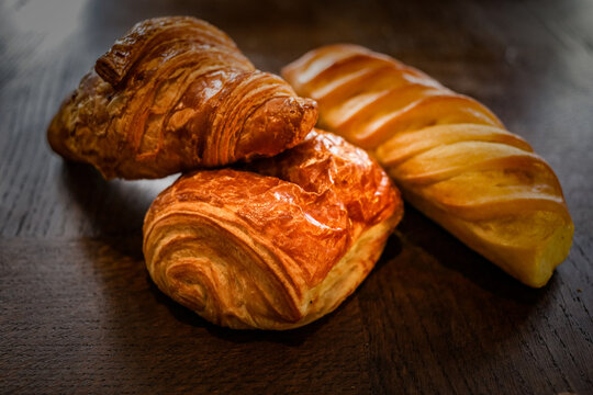 variety of french viennoiseries on wooden surface