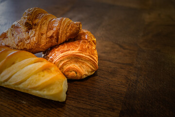 variety of french viennoiseries on wooden surface