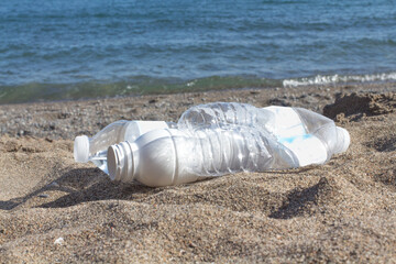ingle use Plastic water bottle pollution washed up on the beach