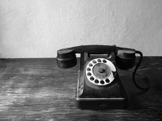 Black and white photo of a vintage retro rotary telephone