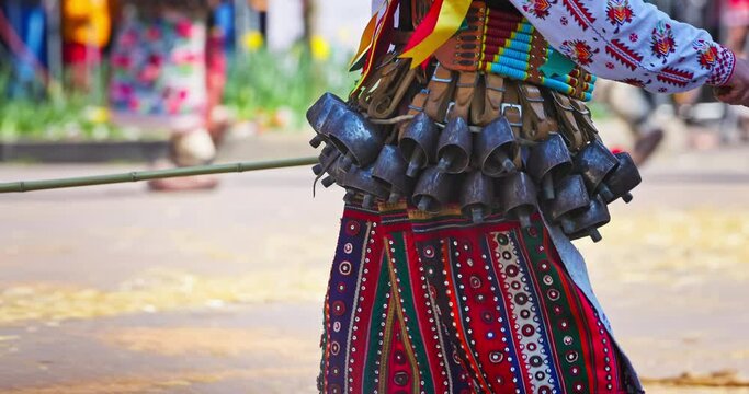 Bulgarian Kukers with bells and traditional costumes, masked people kukeri dancing in masquerade festival Kukerlandia, Yambol, Bulgaria