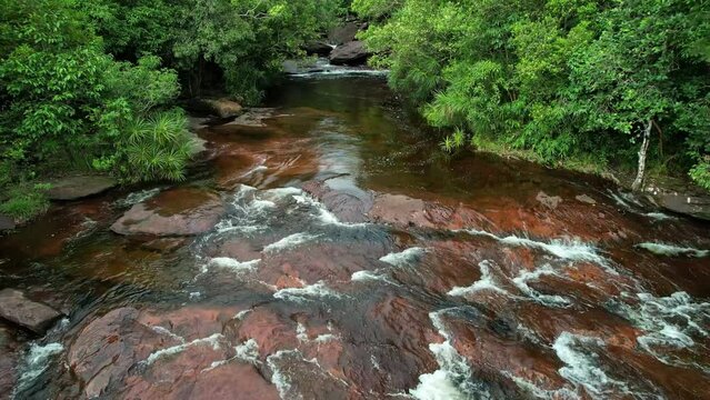 River waterfall cutting through dense greenery in natural landscape Phu Quoc Vietnam Khu du lich sinh thai Suoi Da Ban