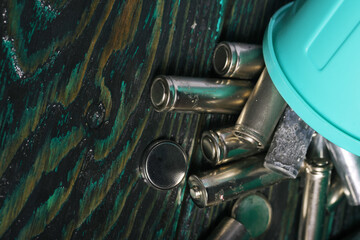 An eco-friendly concept captured in a photo: discarded finger batteries placed in a small bin,...