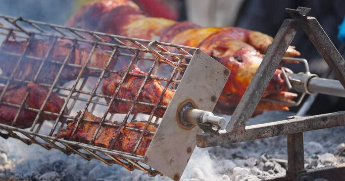 Cheverme traditional bulgarian food roasting meat of split lamb and pork barbecue on outdoor. Piglets grilling on a fire outside video