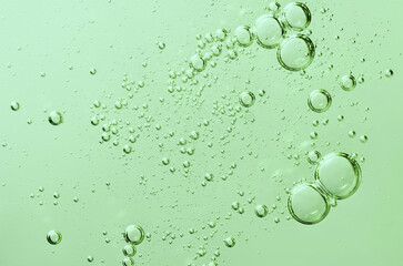 Close up air bubbles on beautiful light green background. Macro photo