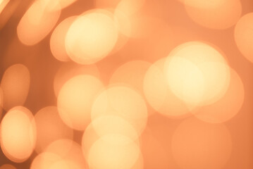 Blurred pastel orange-peach background. Geometric bokeh patterns, trendy color 2024 Peach Fuzz