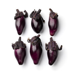 Row of fresh purple mini eggplants isolated on white background close up