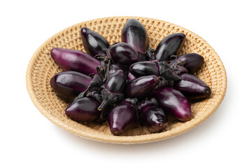 Basket with fresh mini purple eggplants isolated on white background