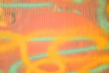 Abstract colored background. Multi-colored drips of paint on a colored wall, texture. Orange and yellow color
