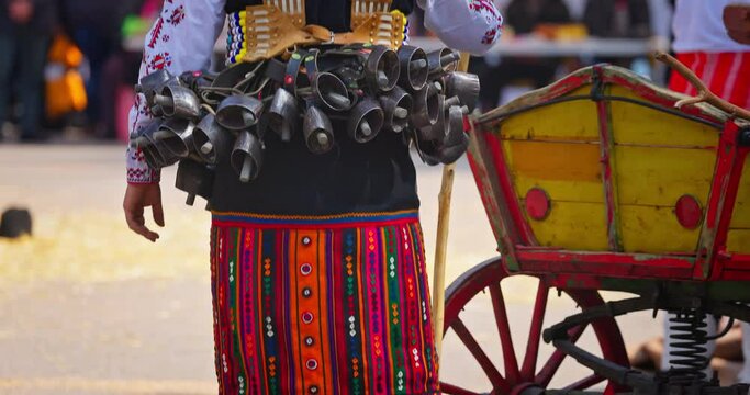 Bulgarian Kukers with bells and traditional costumes, masked people kukeri dancing in masquerade festival Kukerlandia, Yambol, Bulgaria