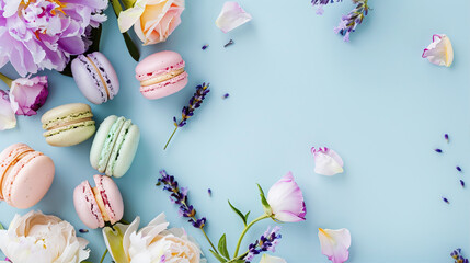 Obraz na płótnie Canvas Macarons and flowers on a blue surface 