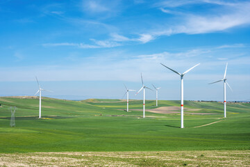 Wind turbines and green agricultural landscape seen in Italy - 788532306