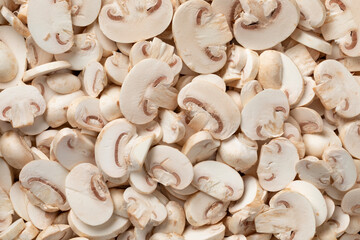 Fresh sliced champignons, Button mushrooms, close up full frame as background