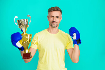 Sport success and victory. Man hold champion cup. Sportsman winner in boxing sport. Successful sport. Mature boxer champion. Celebrating success. Man champion in boxing. Proud of himself - 788535735