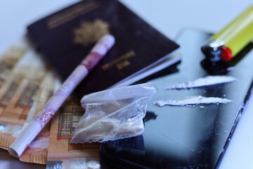 close up cocaïne , banknotes and passport  international drug traffic concept