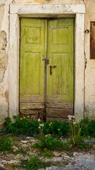  old house wall with wooden light green door  