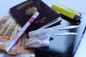 close up cocaïne , banknotes and passport  international drug traffic concept