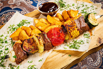 kebab with baked potato and sauce