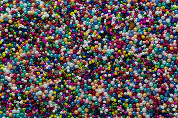 Colorful beads, macro shot. Small stone beads, abstract multicolor background. 