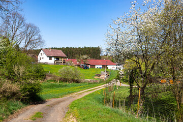 Scenic countryside with village during sunny spring day.