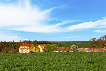 Scenic countryside with village during sunny spring day.
