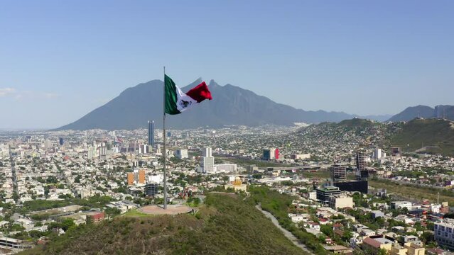 Aerial Forward Shot Of Tall Flag At Mirador Del Obispado On Hill In City - Monterrey, Mexico