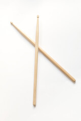 pair of wooden drumsticks on white background