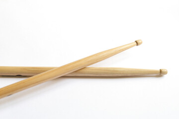 pair of wooden drumsticks on white background