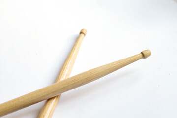 pair of wooden drumsticks on white background