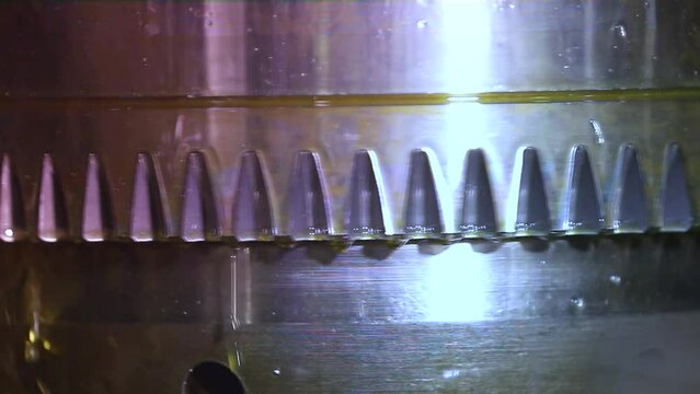 CNC grinding milling machine. CNC turning center. CNC machining high precision turning throwing coolant liquid on metal component during shaping forming process using machining center