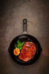 grilled rib eye steak, in a cast-iron skillet, top view, homemade, no people,