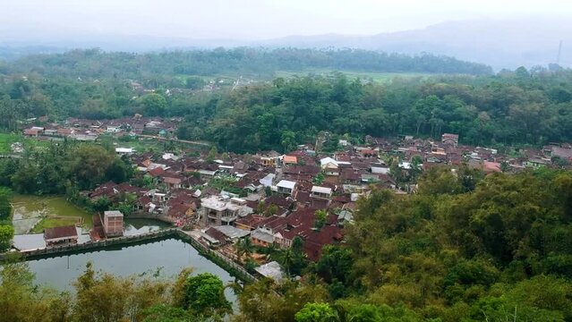 DRONE AERIAL VIEW. a village named Bleder. Location in Ngasinan, Grabag, Magelang, Jawa Tengah, Indonesia. Beautiful village with a lot of green  tree, lake an mountain.