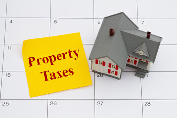 Property Taxes due with house and sticky note on a calendar - 788567774