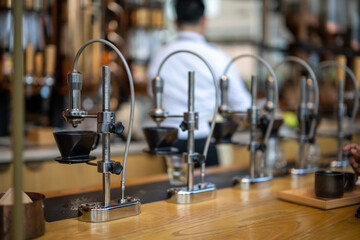 An array of sophisticated manual coffee brewing stands poised for crafting the perfect cup in a modern cafe setting.